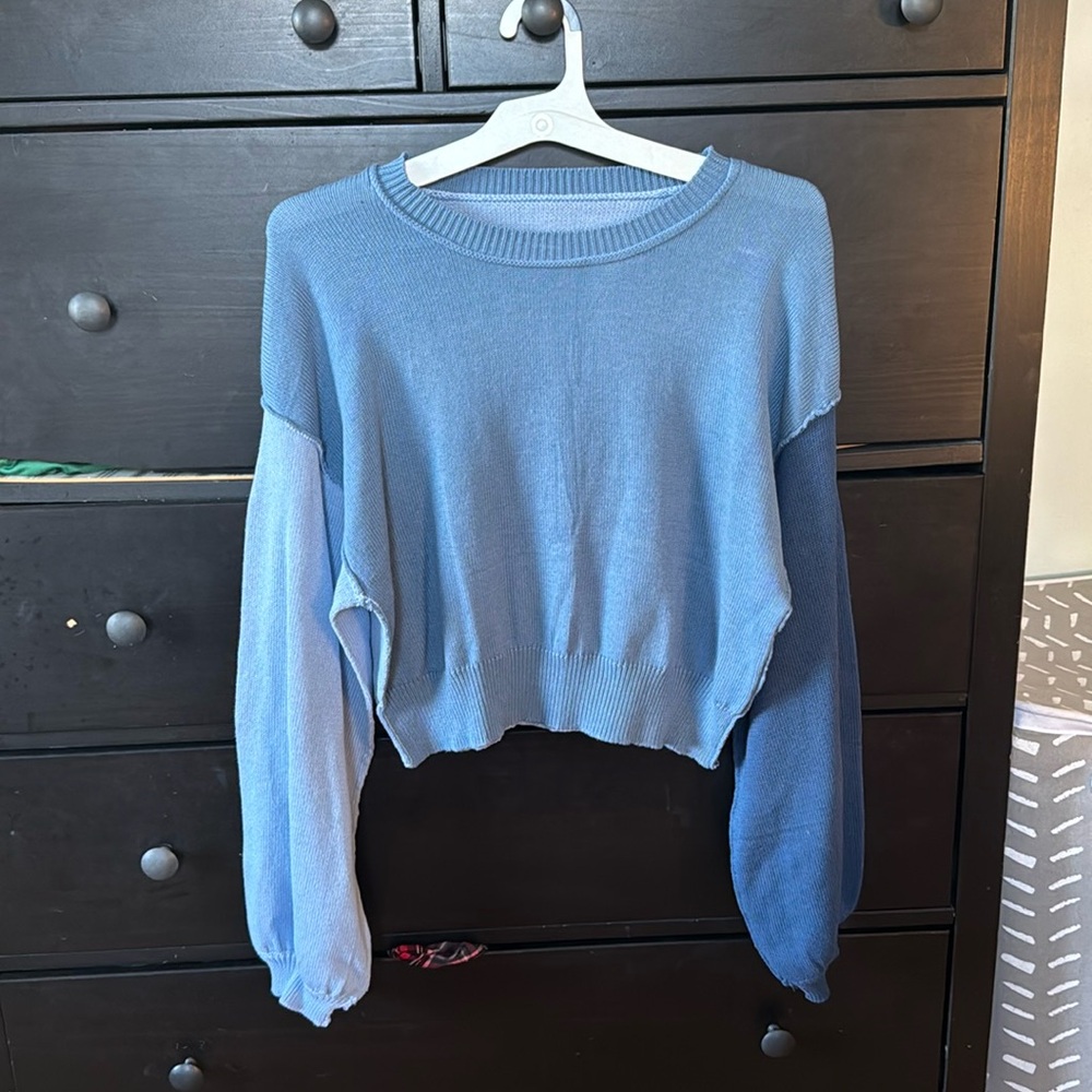 blue sweater with different shaded sleeves